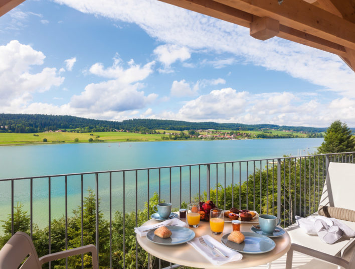 Petit-déjeuner convivial servi en terrasse avec vue splendide sur le Lac Saint Point
