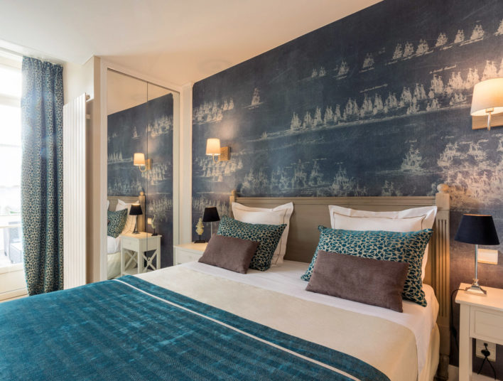 Chambre décoration bleu avec lit double, linge de lit bleu et blanc