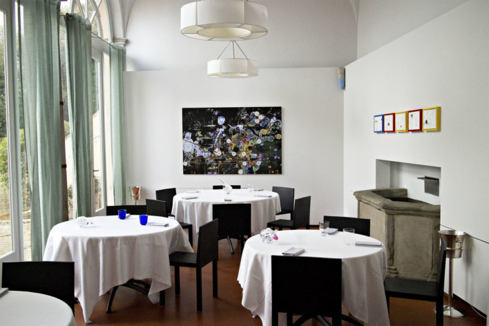 Salle du restaurant avec quatre tables et des chaises de couleurs noir